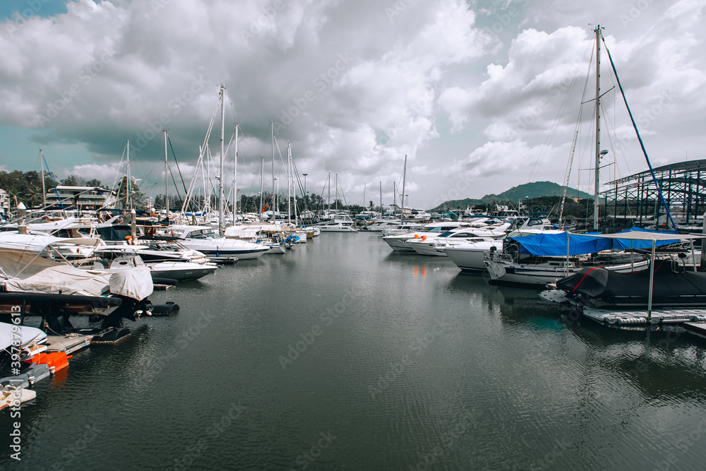 Yacht parking in harbor, harbor yacht club. Long view in the light cloudy sky background