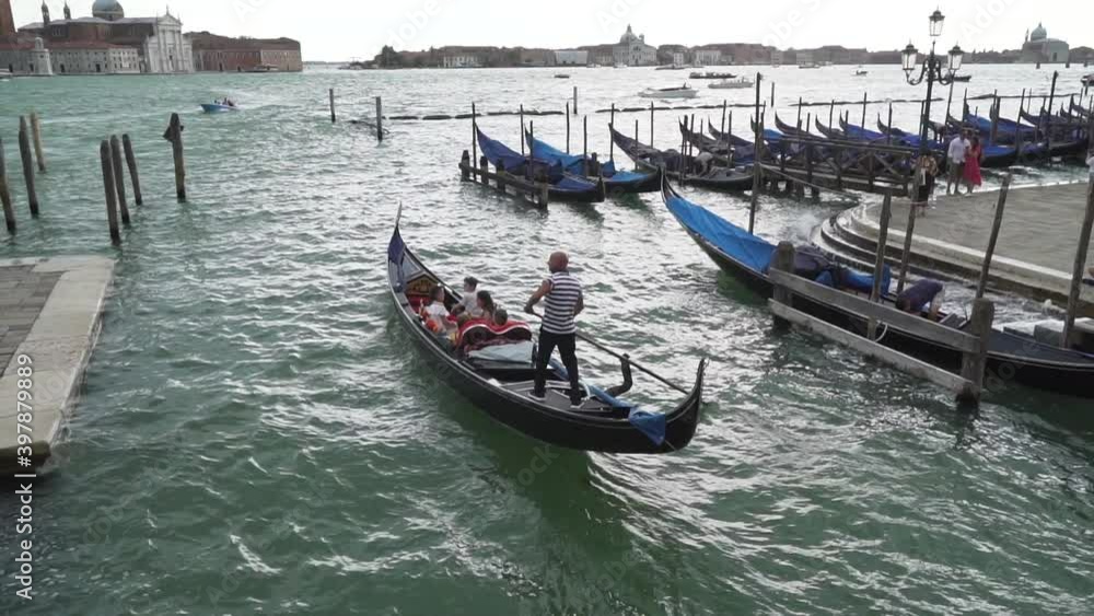 Typical venetian boat sailing in Venice Italy, slow motion Typical venetian boat sailing in Venice Italy, slow motion