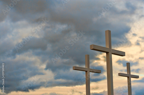 Canvas Print Three crosses seen on hillside under cloudy skies
