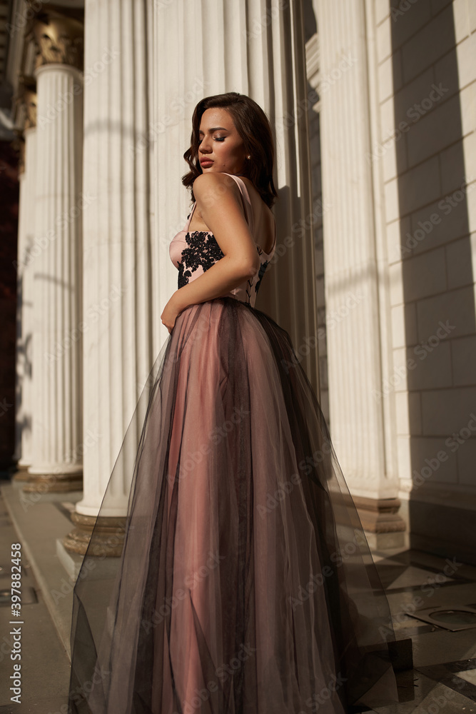 Fototapeta premium Young beautiful woman in an evening dress in the theater