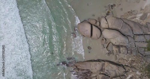 4K summer day aerial camera down video of large boulders at surfing Llandudno Beach, residential suburb of Cape Town on the Atlantic seaboard of the Cape Peninsula in Western Cape in South Africa photo