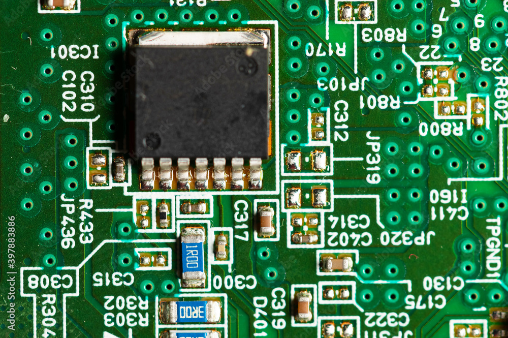 Electronic circuit close-up microchip on a green microcircuit with elements of transistors and strapping Electronic circuit close-up microchip on a green microcircuit with elements of transistors and strapping