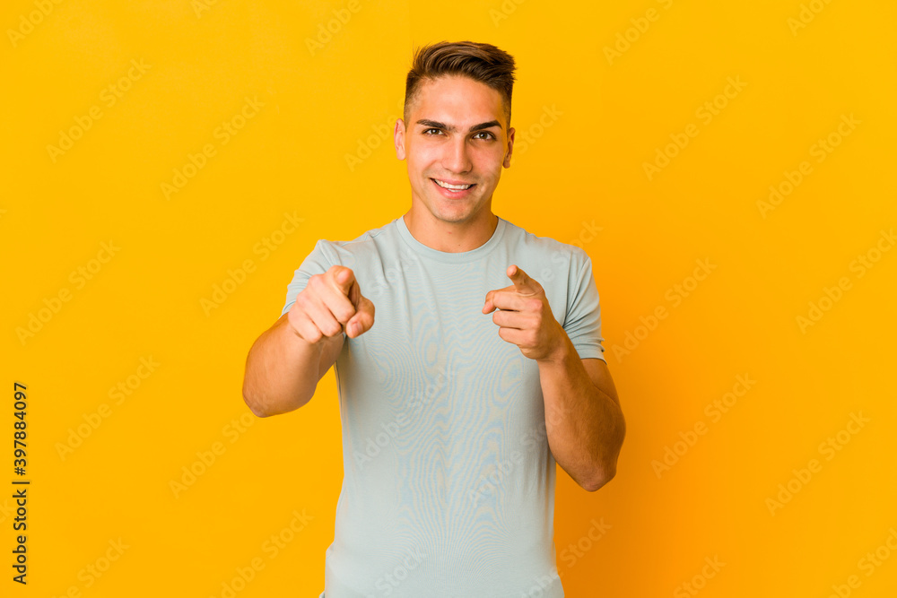Young handsome caucasian man isolated cheerful smiles pointing to front. Young handsome caucasian man isolated cheerful smiles pointing to front.
