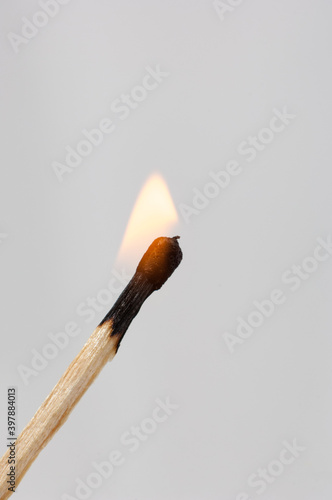 Burning match isolated on grey background