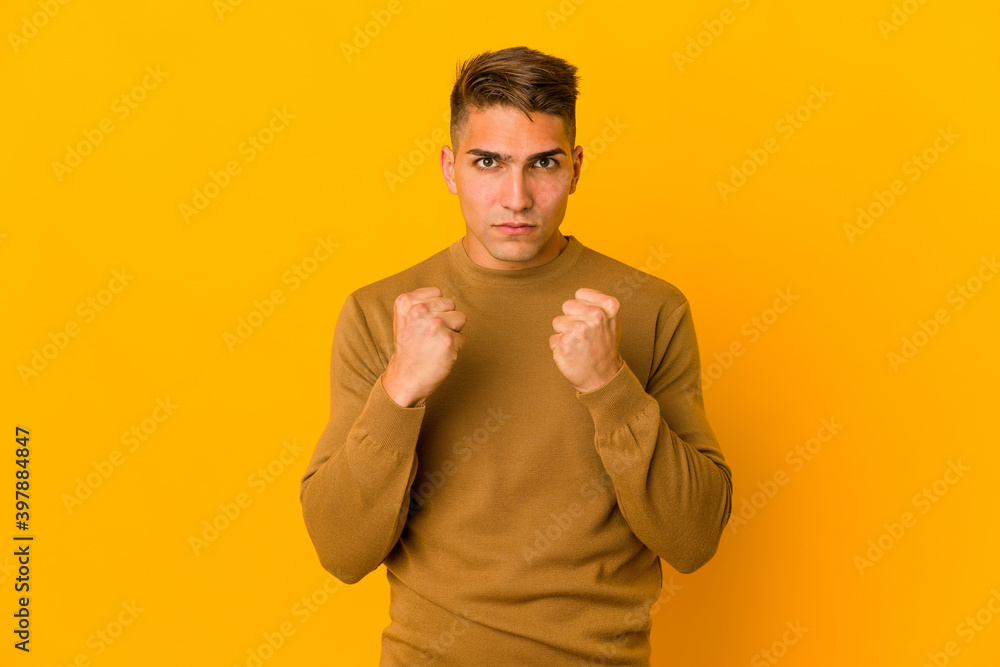 Young handsome caucasian man isolated showing fist to camera, aggressive facial expression. Young handsome caucasian man isolated showing fist to camera, aggressive facial expression.
