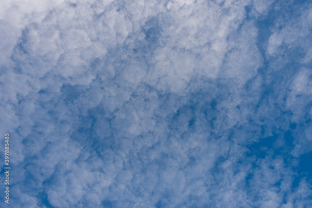 Scattered cloud clusters in a blue sky