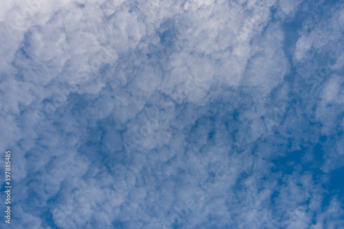 Scattered cloud clusters in a blue sky