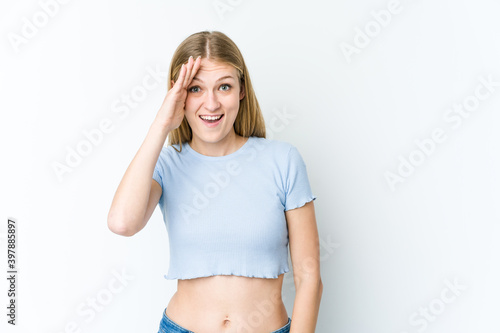 Young blonde woman isolated on white background shouts loud, keeps eyes opened and hands tense.