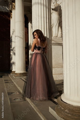 Young beautiful woman in an evening dress in the theater