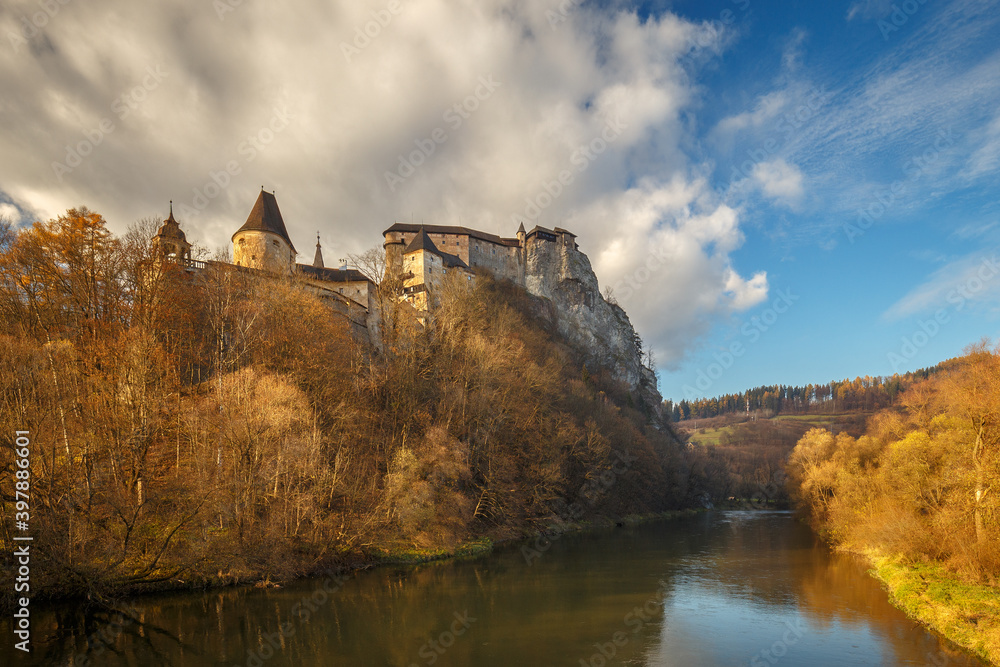 The medieval Orava Castle above a river at autumn, Slovakia, Europe.
