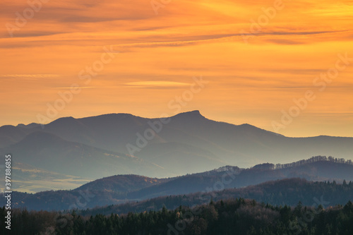Mountains colored in shades of orange at sunset in autumn. The Klak in The Mala Fatra mountain range, Slovakia, Europe. © Viliam