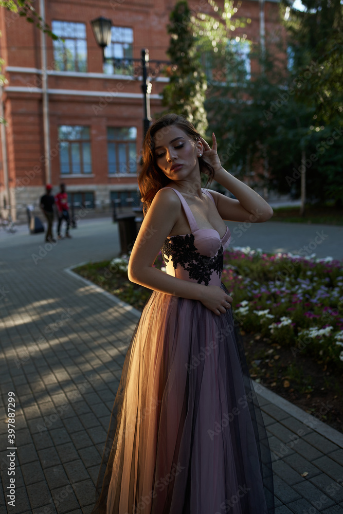 Young beautiful woman in an evening dress in the theater