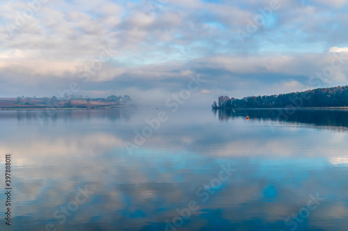 Reflections on the still waters of Pitsford Reservoir, UK in winter