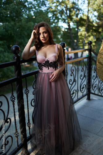 Young beautiful woman in an evening dress in the theater