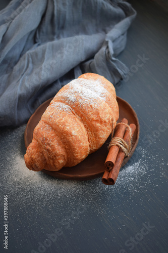 Delicious, fresh croissants isolated on wooden board. French breakfast concept.