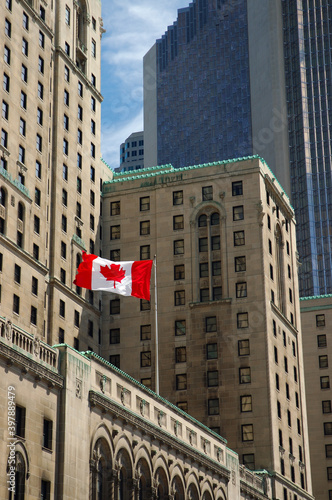 Photography Canadian flag against Royal York hotel and bank towers