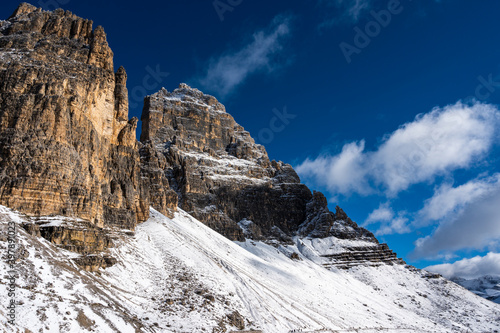 Mountain landscape with snow-capped peaks, the first snow on the peaks of the dolomites in autumn, the mountains turn white.