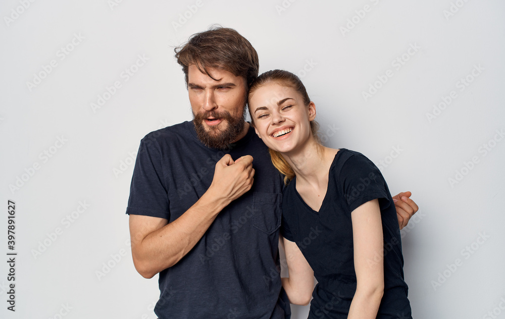 young couple in black t-shirts fun emotions casual clothes studio