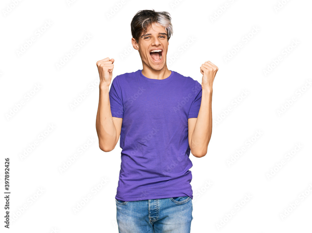Young hispanic man wearing casual clothes screaming proud, celebrating victory and success very excited with raised arms Young hispanic man wearing casual clothes screaming proud, celebrating victory and success very excited with raised arms