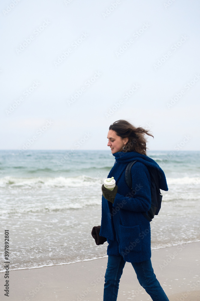 Beautiful caucasian woman walking by the sea Beautiful caucasian woman walking by the sea