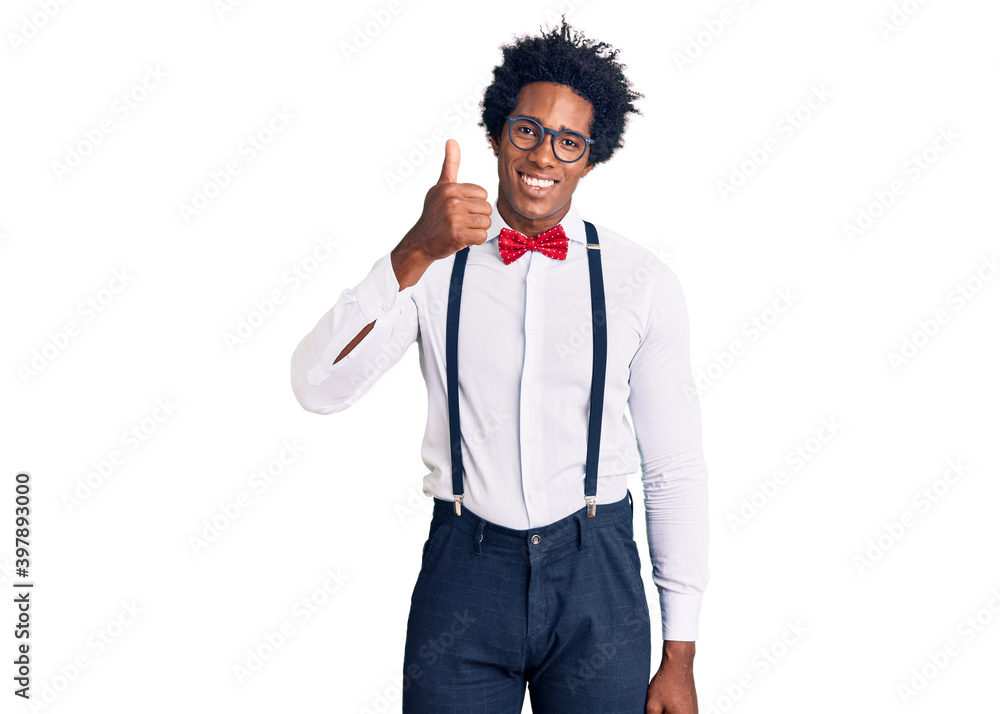 Handsome african american man with afro hair wearing hipster elegant look smiling happy and positive, thumb up doing excellent and approval sign Handsome african american man with afro hair wearing hipster elegant look smiling happy and positive, thumb up doing excellent and approval sign