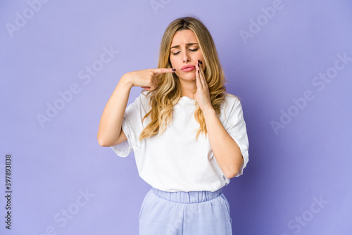 Young caucasian blonde woman having a strong teeth pain, molar ache.