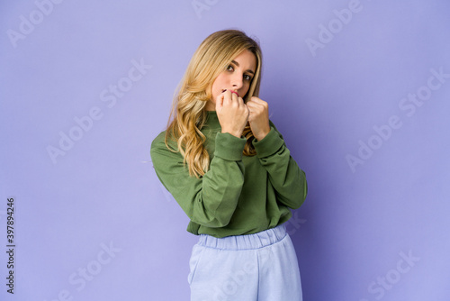 Young caucasian blonde woman throwing a punch, anger, fighting due to an argument, boxing.