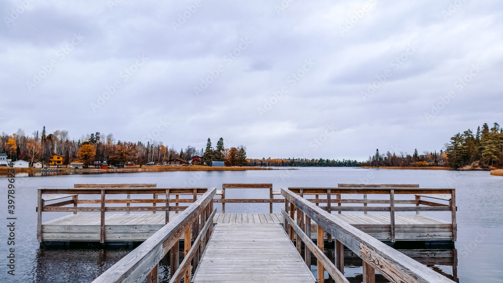 Peaceful dock on a calm lake in fall