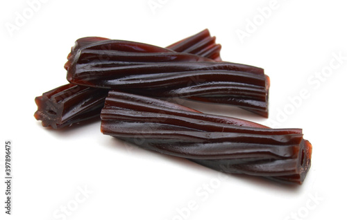 Black licorice candies isolated on white background  photo