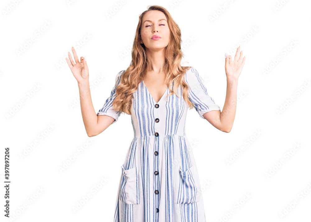 Young caucasian woman with blond hair wearing summer dress relax and smiling with eyes closed doing meditation gesture with fingers. yoga concept. Young caucasian woman with blond hair wearing summer dress relax and smiling with eyes closed doing meditation gesture with fingers. yoga concept.