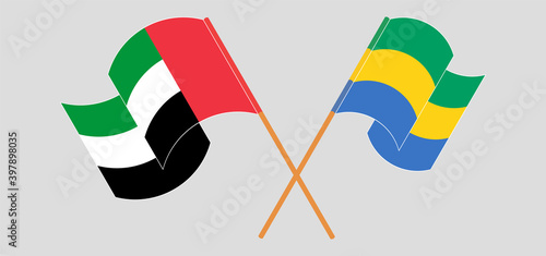 Crossed and waving flags of the United Arab Emirates and Gabon