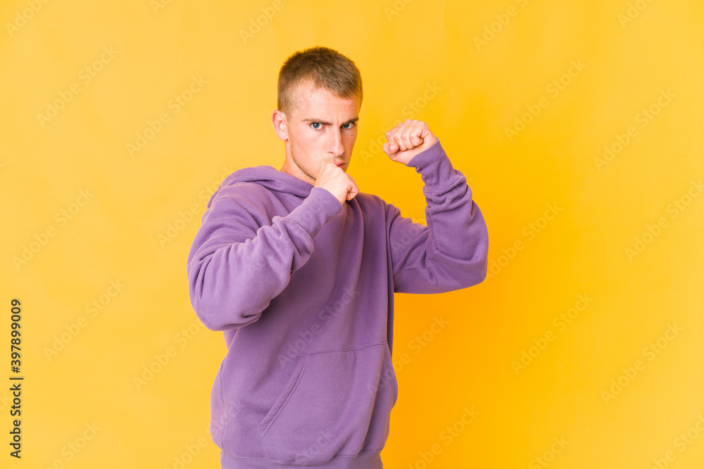 Young caucasian handsome man throwing a punch, anger, fighting due to an argument, boxing. Young caucasian handsome man throwing a punch, anger, fighting due to an argument, boxing.