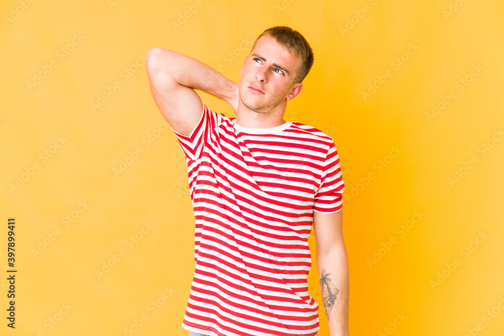 Young caucasian handsome man having a neck pain due to stress, massaging and touching it with hand. Young caucasian handsome man having a neck pain due to stress, massaging and touching it with hand.
