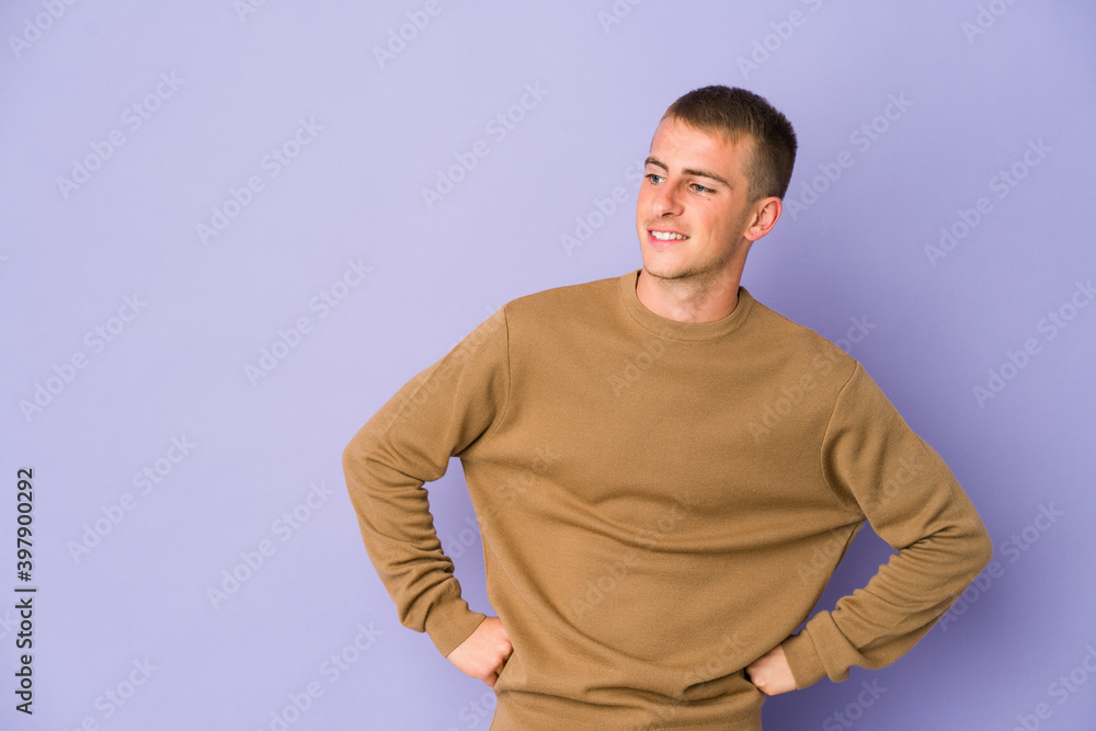 Young caucasian handsome man laughs happily and has fun keeping hands on stomach. Young caucasian handsome man laughs happily and has fun keeping hands on stomach.