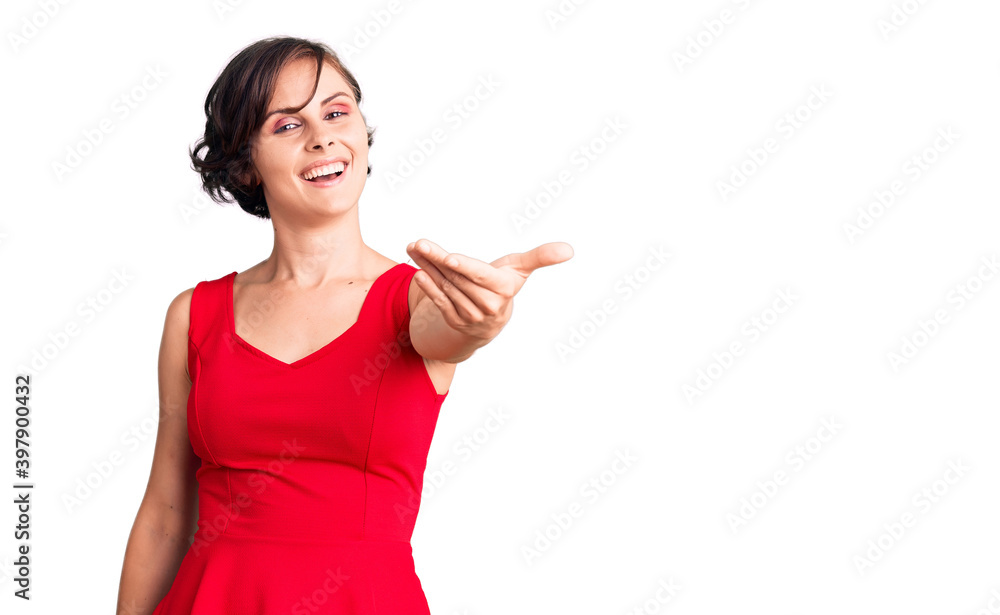 Beautiful young woman with short hair wearing casual style with sleeveless shirt smiling friendly offering handshake as greeting and welcoming. successful business. Beautiful young woman with short hair wearing casual style with sleeveless shirt smiling friendly offering handshake as greeting and welcoming. successful business.