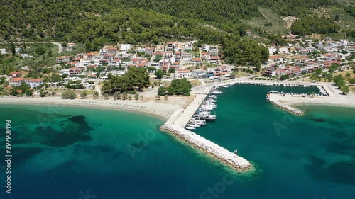 Aerial drone video of small fishing village of Neo Klima with nearby popular beach of Hovolos, Skopelos island, Sporades, Greece photo