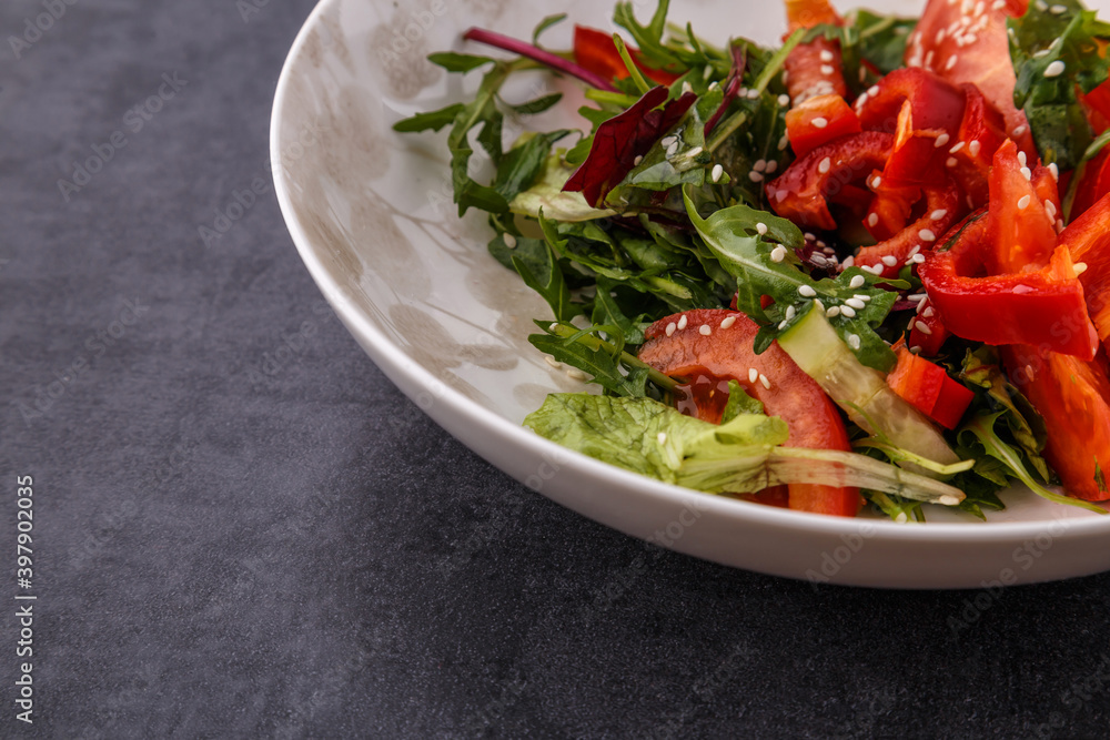 Vegan Spring Salad. Tomato, lettuce, dressing, bell peppers and avocados. Fork with vegetables and salad. Vegan Spring Salad. Tomato, lettuce, dressing, bell peppers and avocados. Fork with vegetables and salad.