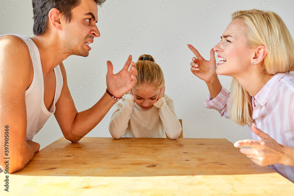 little girl sit hearing her parents yelling at each other, sad child