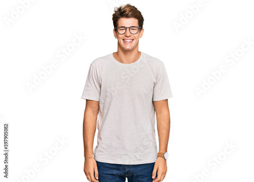 Handsome caucasian man wearing casual clothes and glasses with a happy and cool smile on face. lucky person.