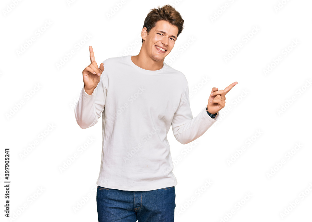 Handsome caucasian man wearing casual white sweater smiling confident pointing with fingers to different directions. copy space for advertisement Handsome caucasian man wearing casual white sweater smiling confident pointing with fingers to different directions. copy space for advertisement