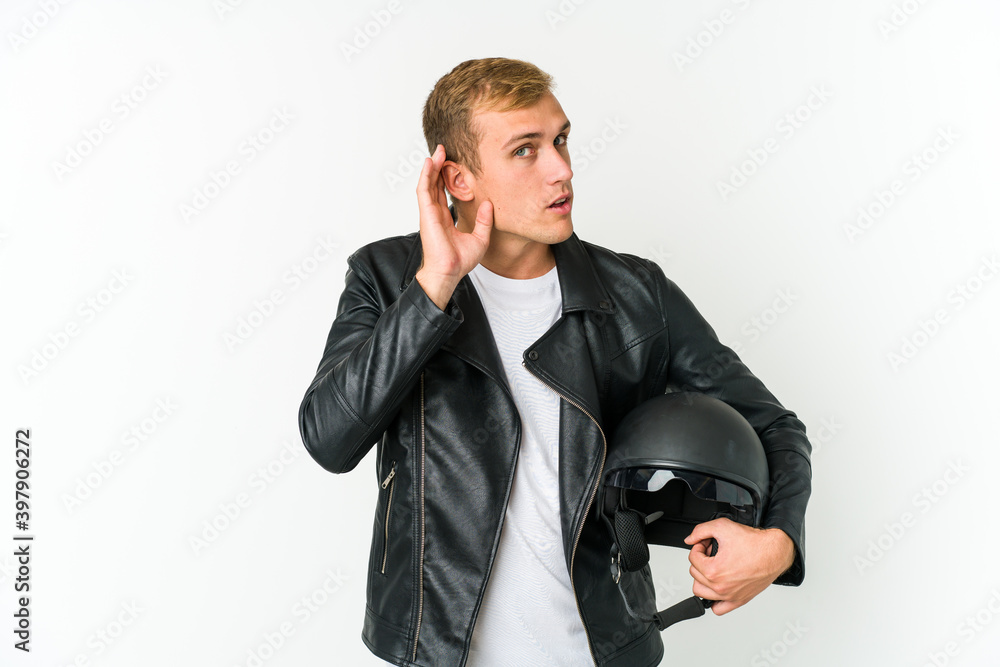 Young caucasian man holding a motorbike helmet isolated on white background Young caucasian man holding a motorbike helmet isolated on white background