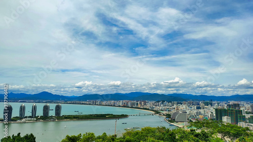 Phoenix Island (Fenghuangling Haishishanmeng Scenic Area) and Sanya Bay Beach. Residential houses and Hotels. South China Sea. Hainan Island. Asia.