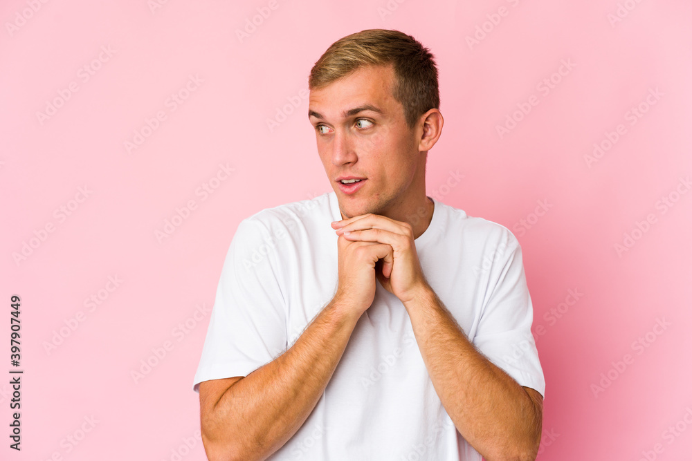 Young caucasian handsome man praying for luck, amazed and opening mouth looking to front. Young caucasian handsome man praying for luck, amazed and opening mouth looking to front.