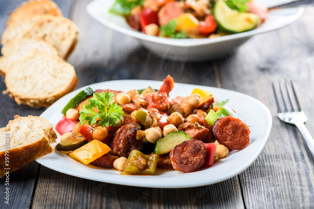 Spanish pot - pot meal with vegetables and sausage Spanish pot - pot meal with vegetables and sausage