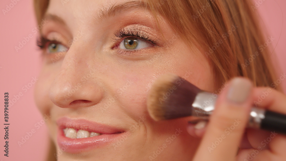 Beauty shot. Young caucasian woman with make up brush near her face. . High quality photo Beauty shot. Young caucasian woman with make up brush near her face. . High quality photo
