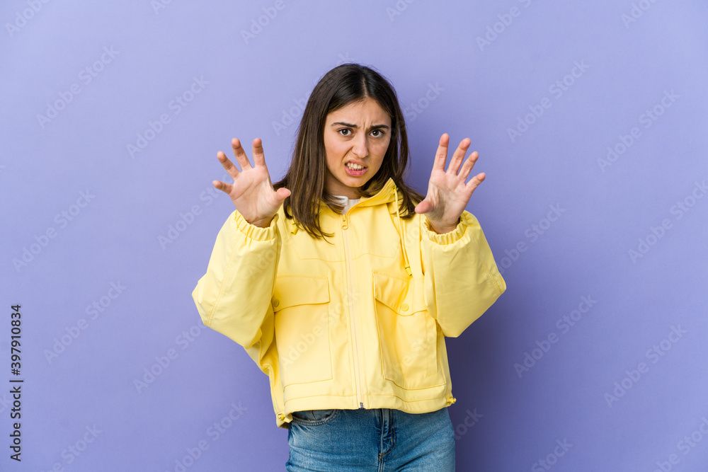 Young caucasian woman showing claws imitating a cat, aggressive gesture. Young caucasian woman showing claws imitating a cat, aggressive gesture.