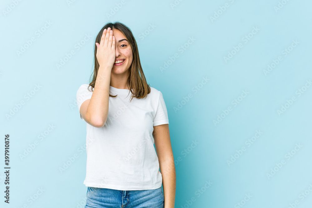 Young caucasian woman having fun covering half of face with palm. Young caucasian woman having fun covering half of face with palm.