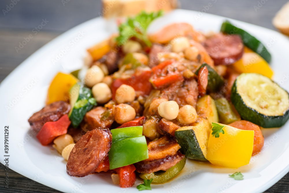 Spanish pot - pot meal with vegetables and sausage Spanish pot - pot meal with vegetables and sausage