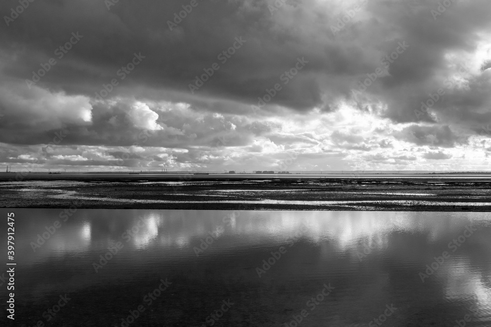 Fototapeta premium Reflections on Chalkwell beach, near Southend-on-Sea, Essex, England