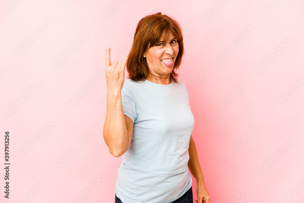 Senior caucasian woman isolated showing rock gesture with fingers Senior caucasian woman isolated showing rock gesture with fingers
